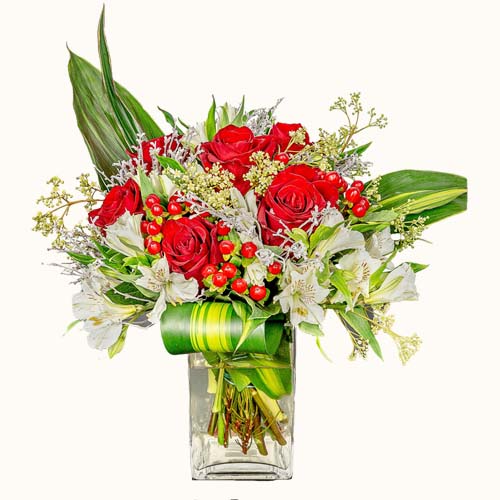Red 'Ardent Love' flowers in a small glass vase