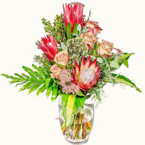 Multicoloured 'Caribbean Sunrise' flowers in a small glass vase