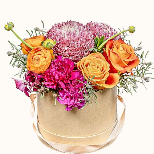Pink and orange 'Pastel Wonderland' flowers in a small wooden box