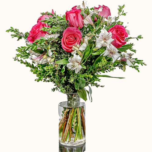 Red and white 'Soho Sweetness' flowers in a small glass vase