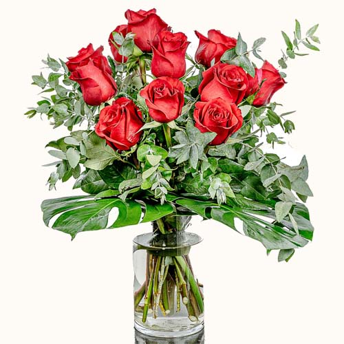 'The Red Queen' flowers in a small glass vase